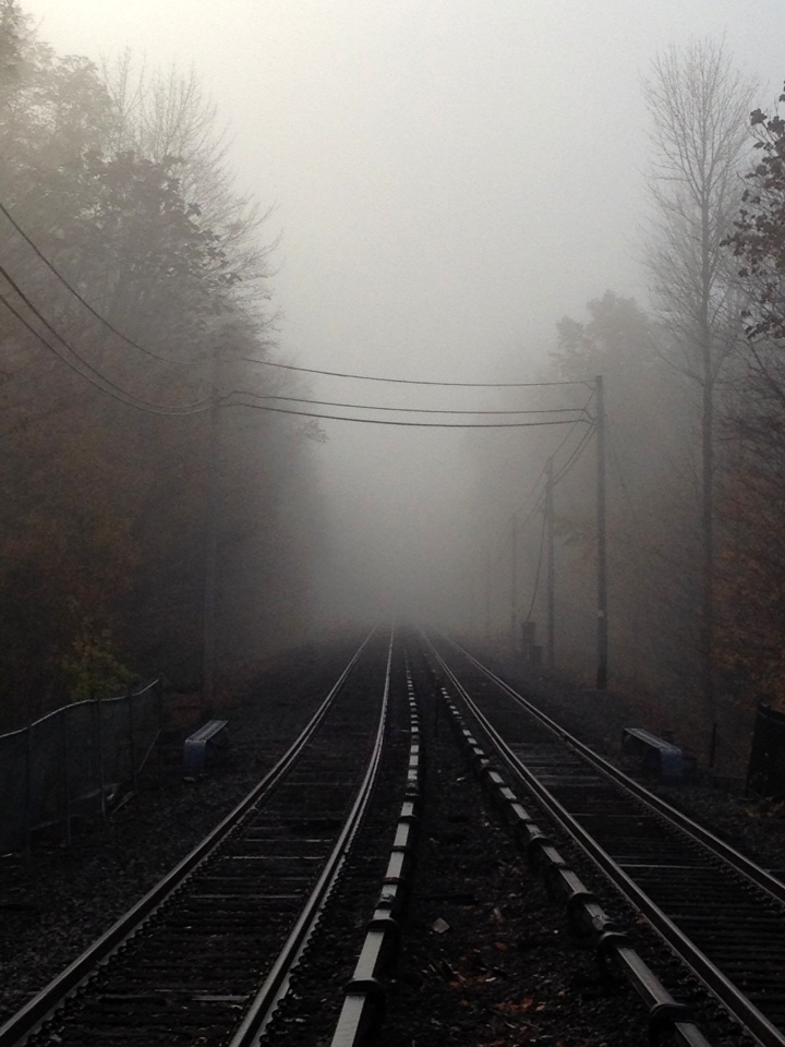 About the same time at the train station, fog is creeping in on the track.